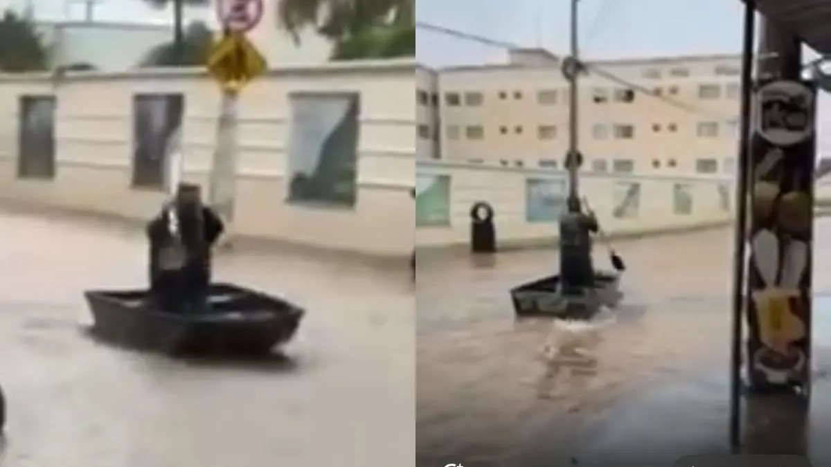 homem-usa-barco-para-transitar-por-rua-alagada-em-caldas-novas-apos-forte-chuva;-video